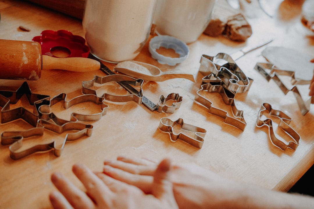 cookie-cutters-and-rolling-pin-on-a-wooden-table-bqgayb-aums